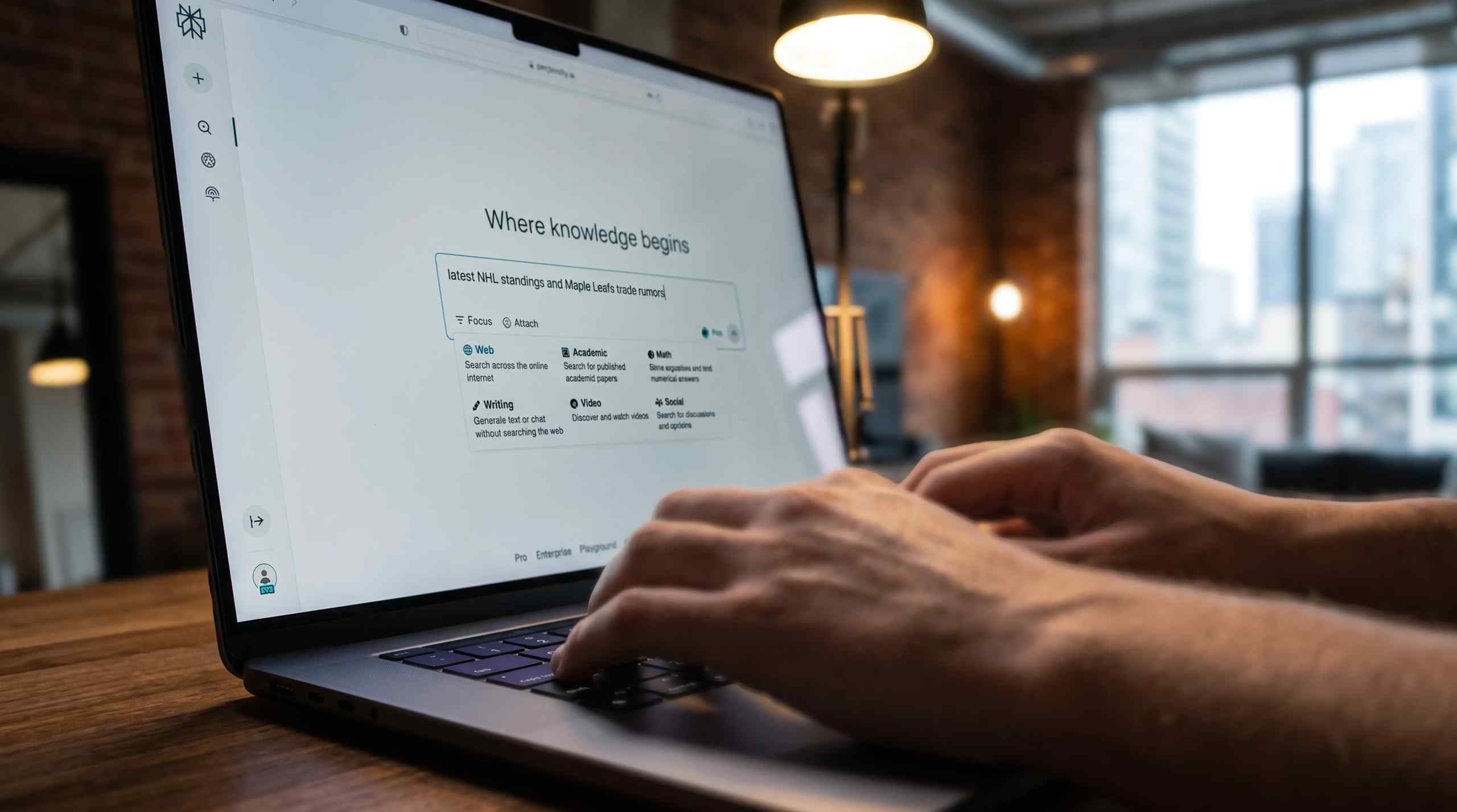 A man typing on a laptop with Perplexity running on the screen.